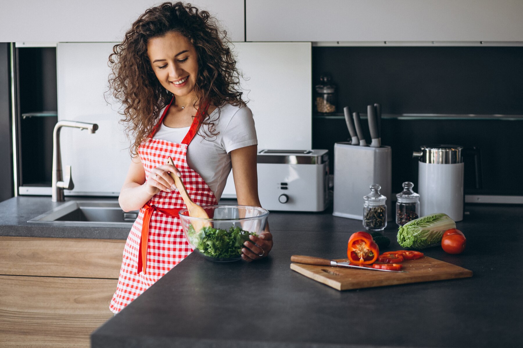 woman-making-salad-kitchen_1303-22254